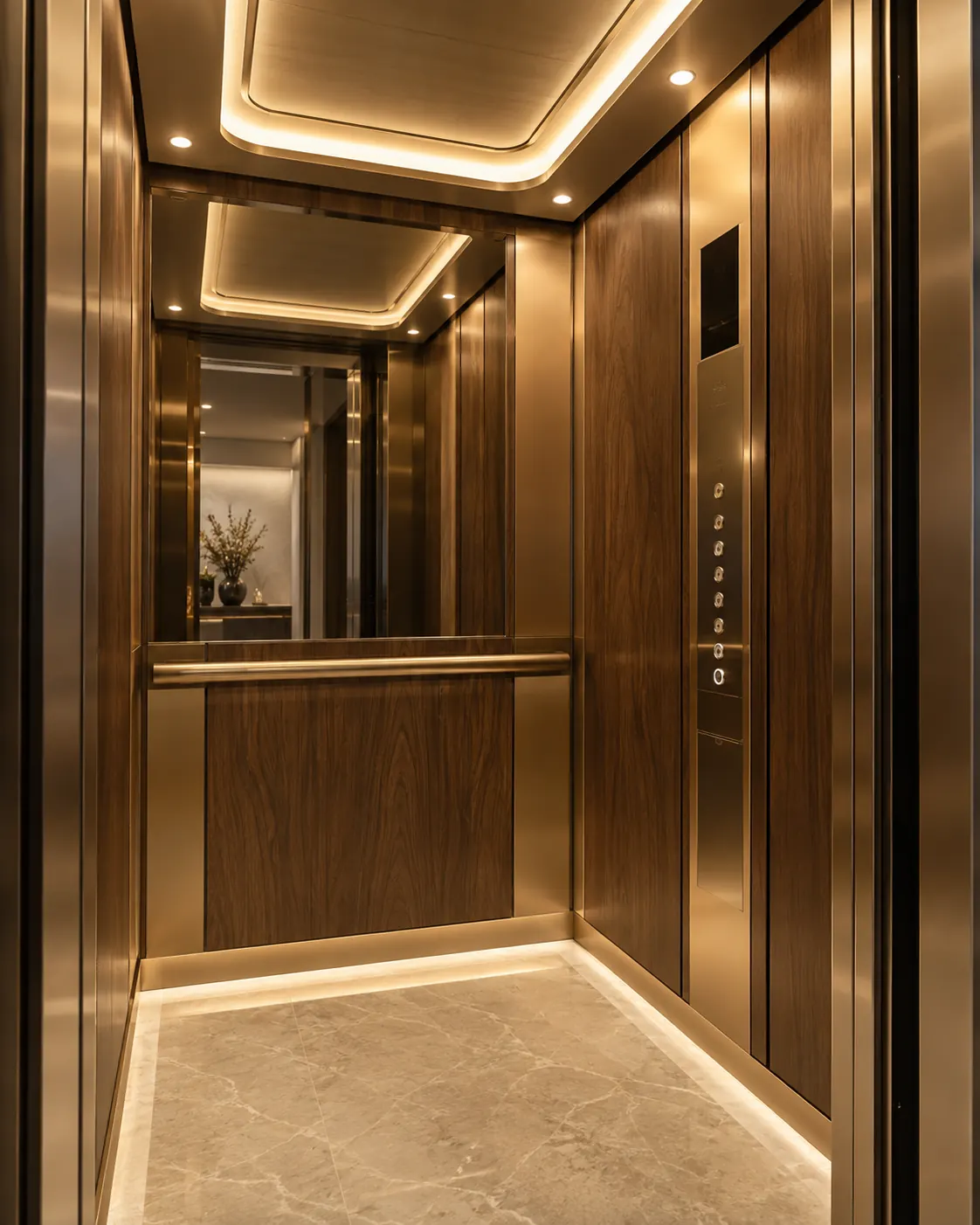 Lift cabin with bronze-toned finishes and linear lighting